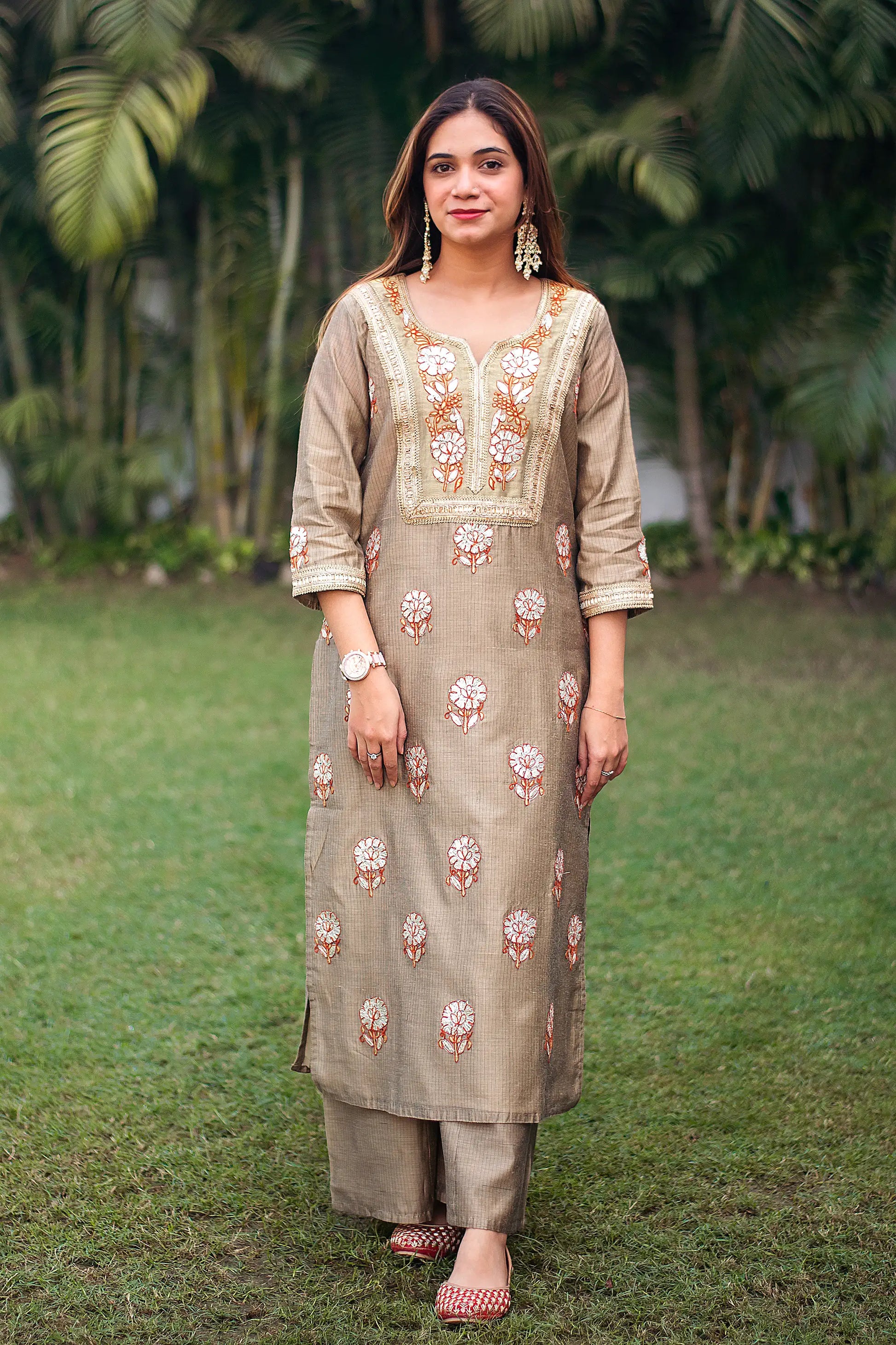 Indian model in a beige Chanderi kurta with golden gota patti work, paired with beige palazzo.