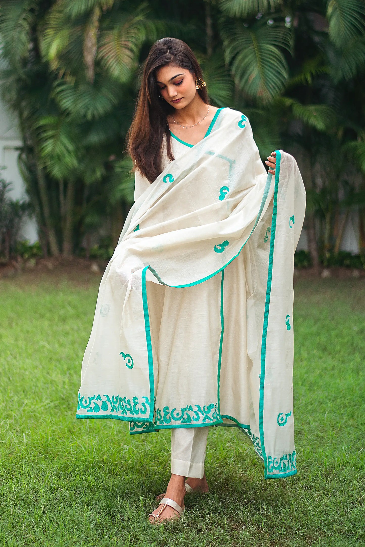 Model wearing the beige chanderi angrakha set in an elegant pose, highlighting the ensemble's style