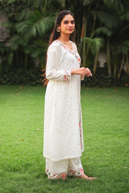 An Indian girl posing in off-white Angarkha style kurta