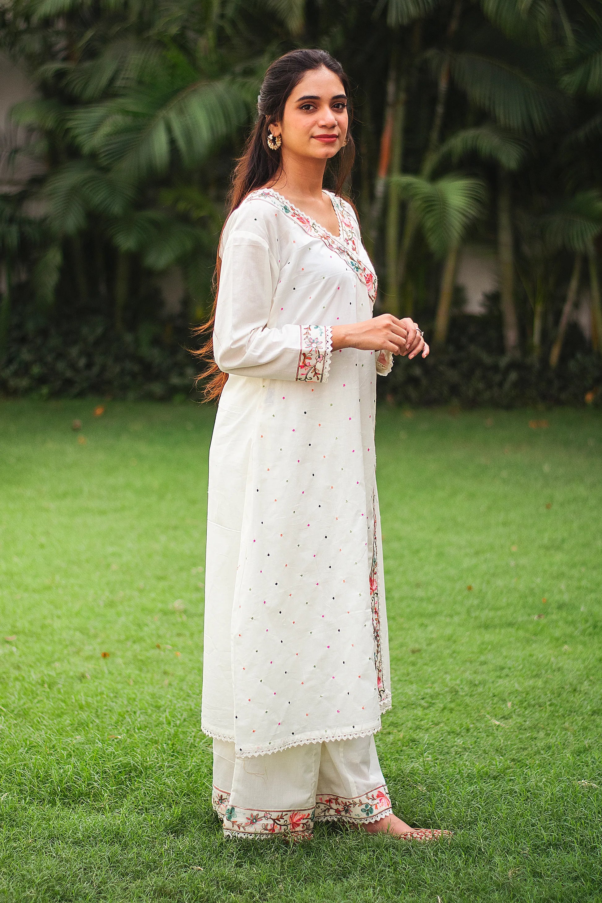 An Indian girl posing in off-white Angarkha style kurta