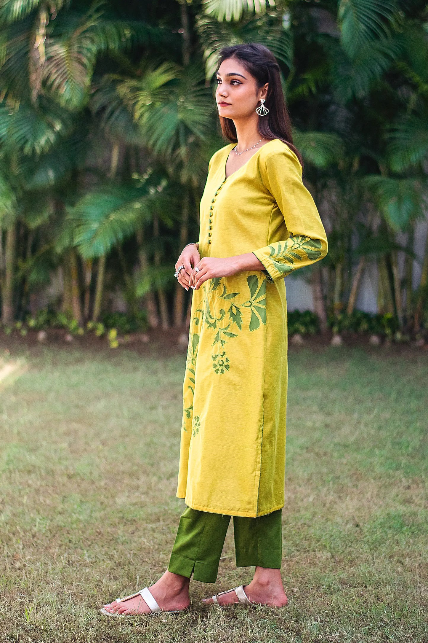 Left side view of a model wearing the cutwork kurta set, highlighting the straight fit kurta's elegant silhouette