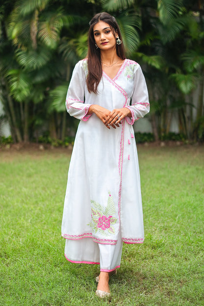 Indian model in a white chanderi angrakha with pink floral and green leaf embroidery, paired with white palazzo