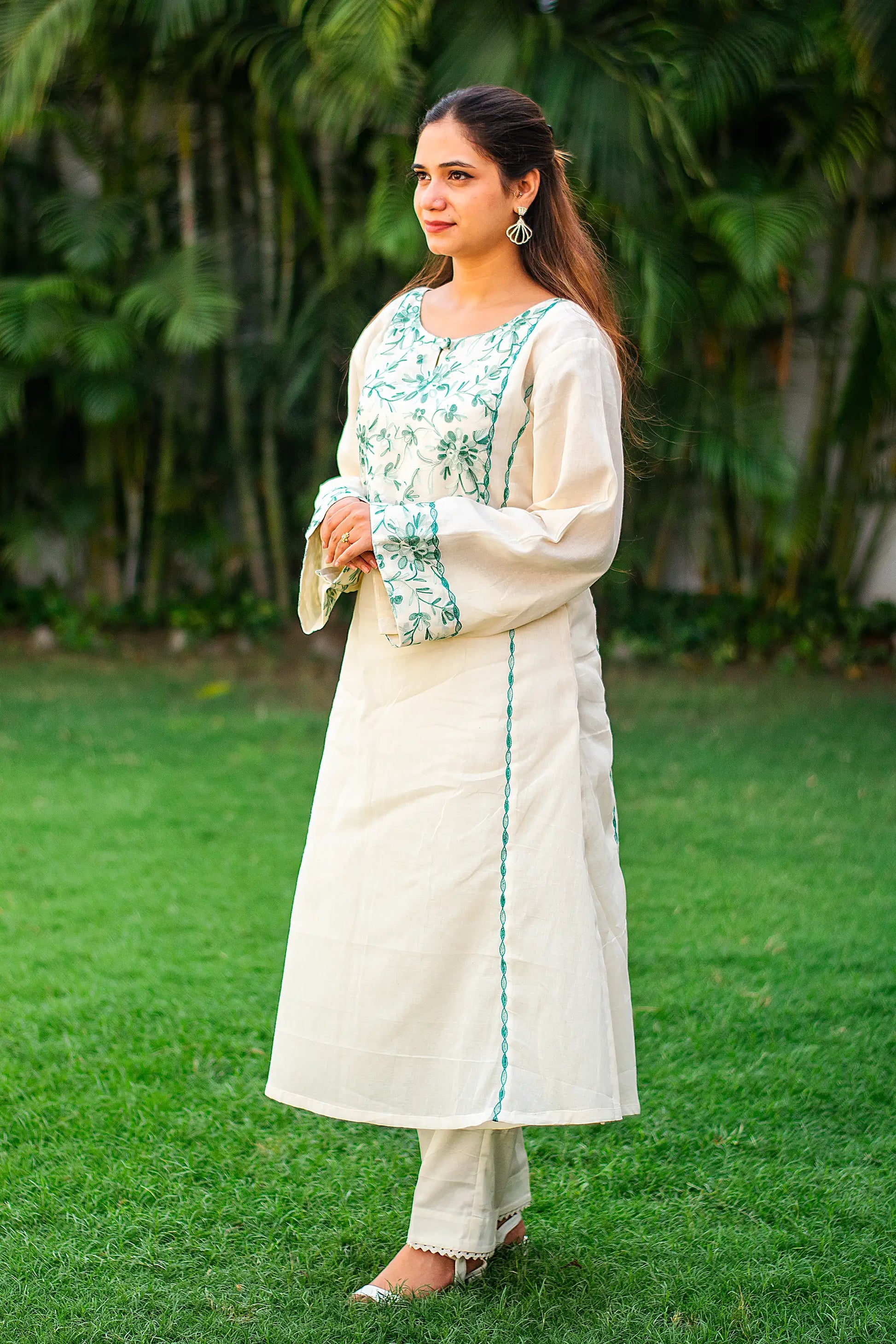 ndian model in a side profile, highlighting the kalidar kurta and plain trousers.