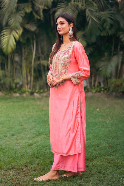 Side view of an Indian model in a peach chanderi kurta with zardozi work, complemented by a matching peach palazzo.