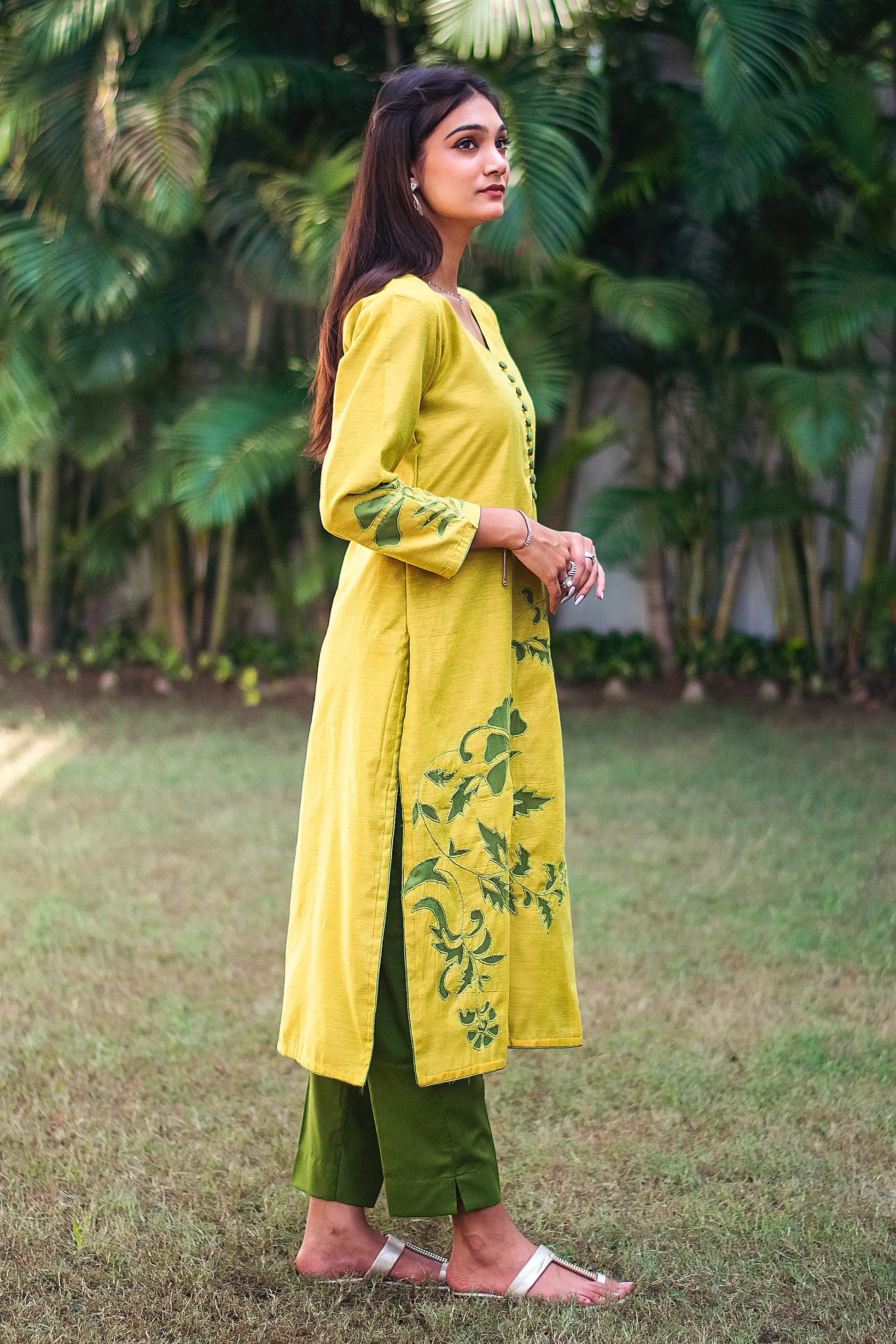 Right side view of a model wearing the cutwork kurta set, highlighting the straight fit kurta's elegant silhouette