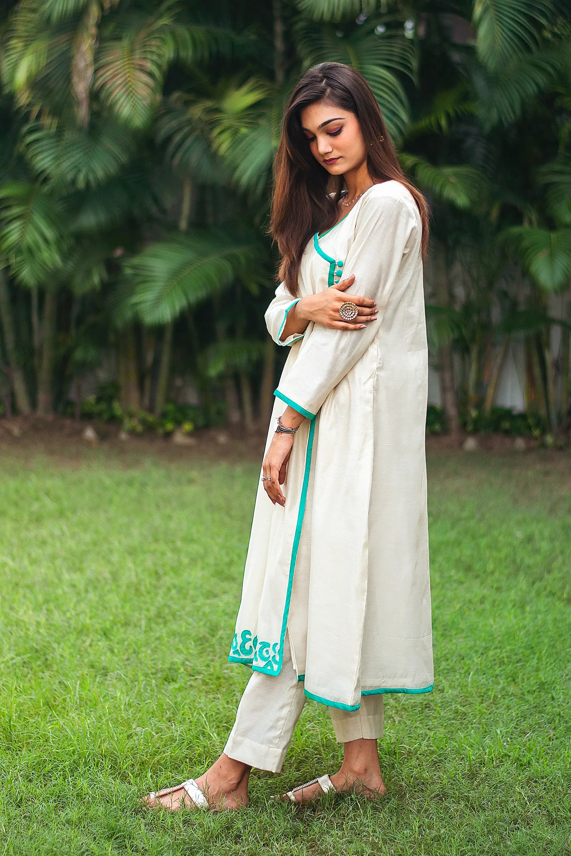 Left side view of a model wearing the beige chanderi angrakha set, highlighting the timeless angrakha silhouette