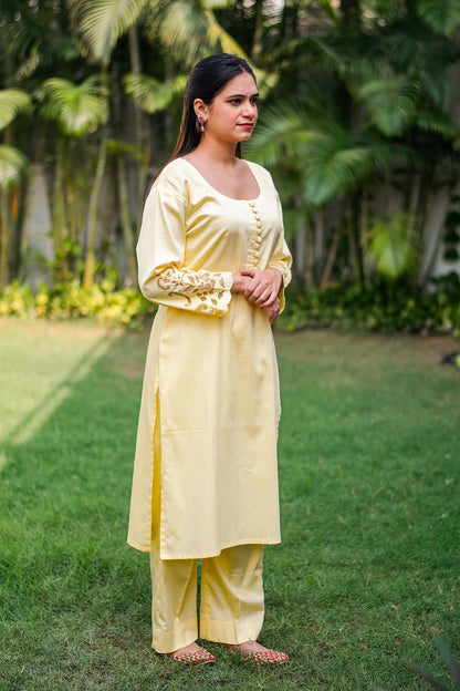 Pastel yellow russian silk kurta & trousers, peach chanderi dupatta with cutwork