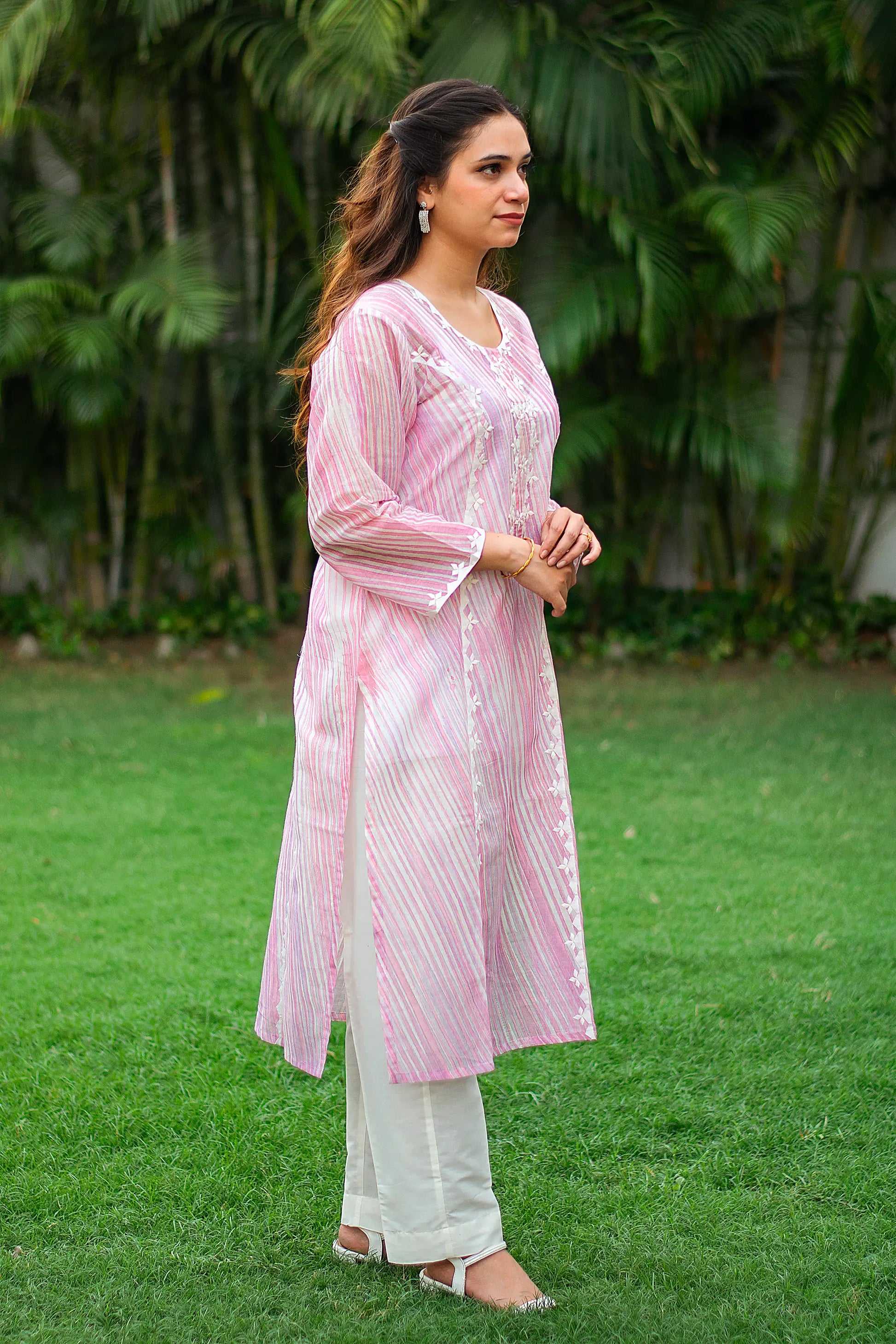 Indian model in a side profile, highlighting the kalidar silhouette kurta and plain trousers.