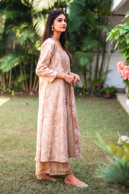 Right side view of a model wearing the beige floral print kurta set, highlighting the angrakha-style kurta's unique silhouette