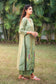 Right side view of a model wearing the green kurta set, highlighting the silhouette of the angarkha.
