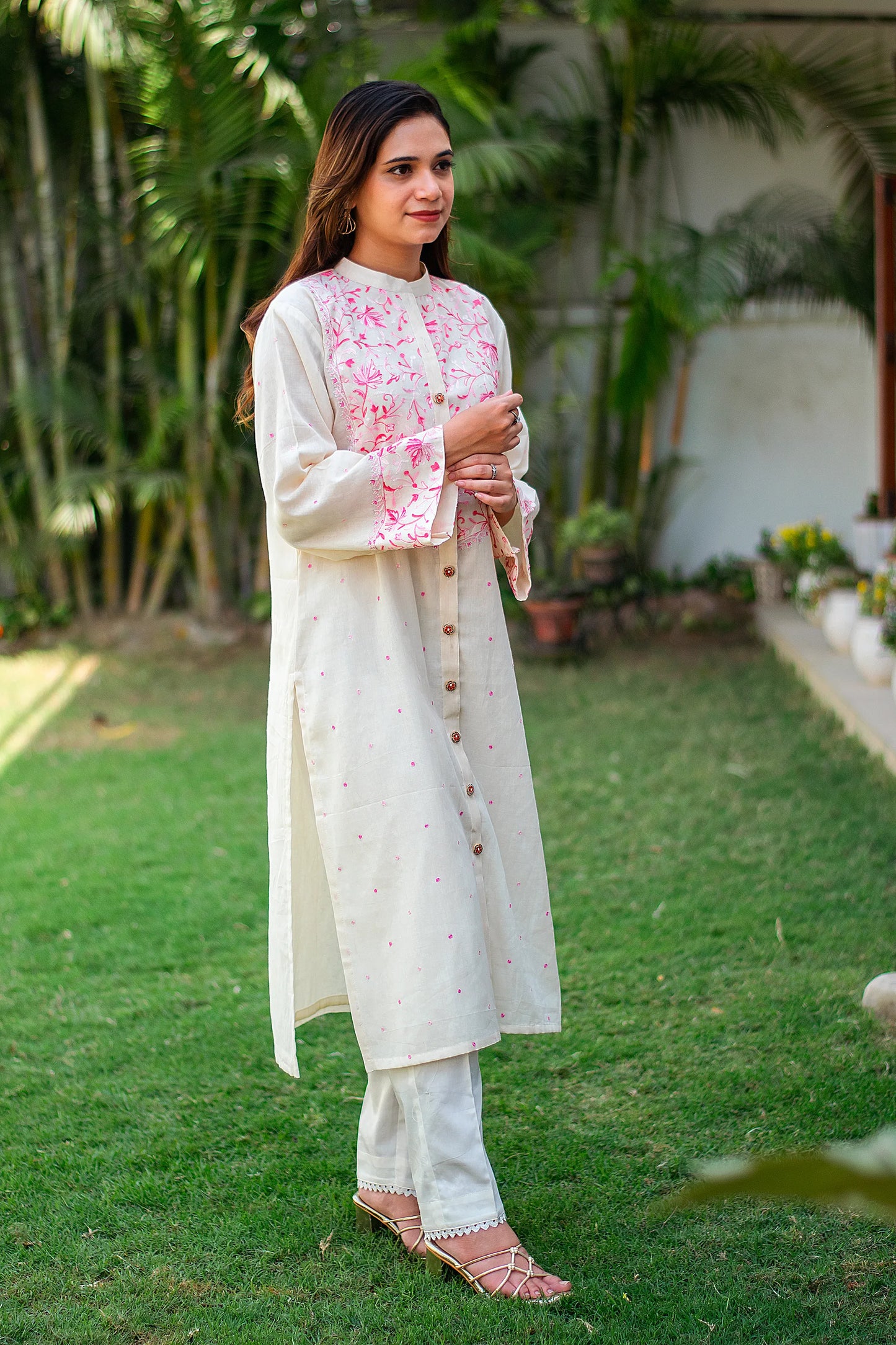  Indian model in a side profile, highlighting the embroidered kurta and plain trousers.