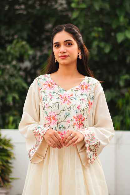 A young Indian woman poses in a Bahaar-e-Chinaar off-white cotton frock kurta set.