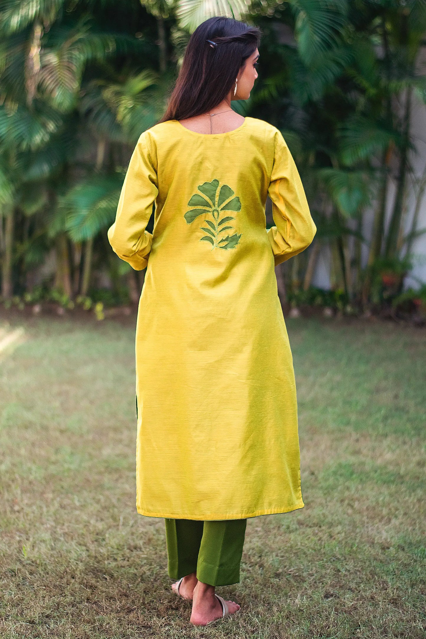 Back view of a model wearing the cutwork kurta set showcasing the cutwork flower at the back