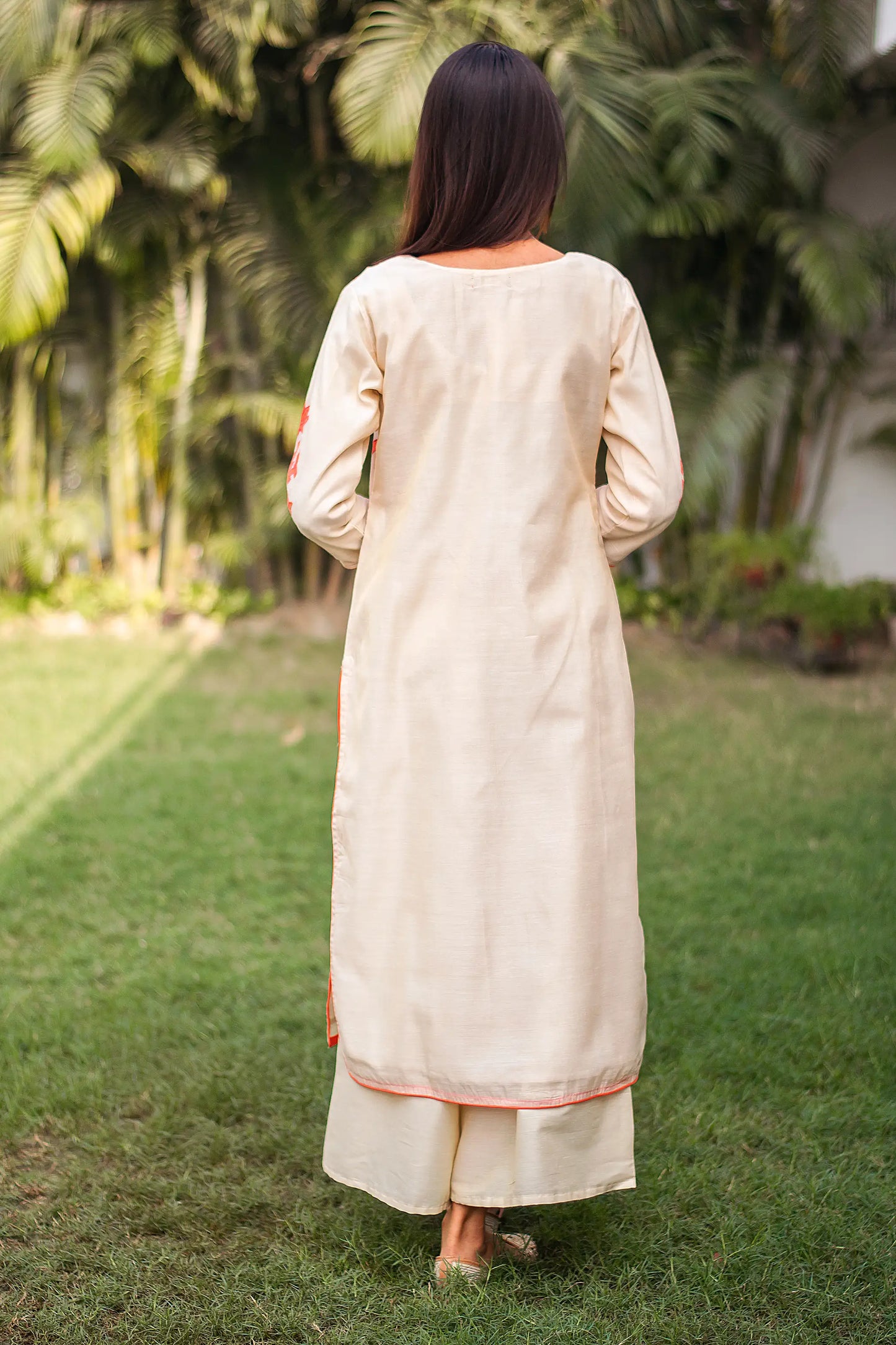 Back view of an Indian model wearing a beige chanderi kurta, paired with beige palazzo.