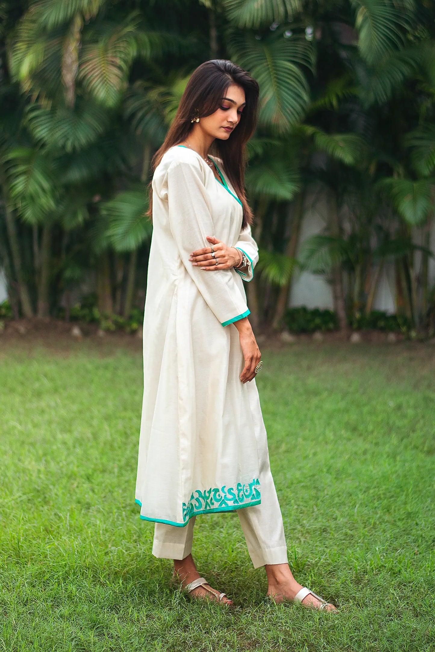 RIght side view of a model wearing the beige chanderi angrakha set, highlighting the timeless angrakha silhouette