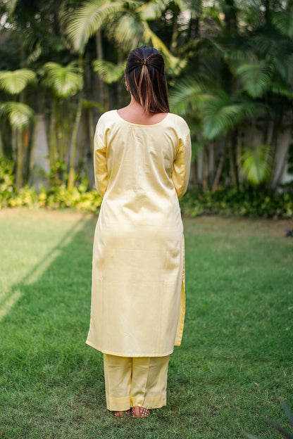 Pastel yellow russian silk kurta & trousers, peach chanderi dupatta with cutwork