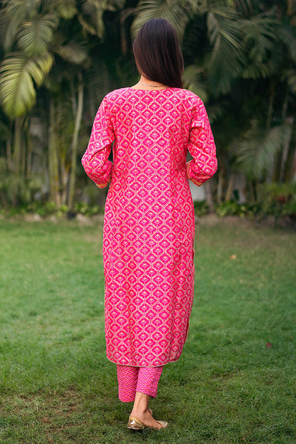 Back view of an Indian model wearing a magenta chanderi kurta with foil-printed Mughal motifs, paired with matching magenta trousers.