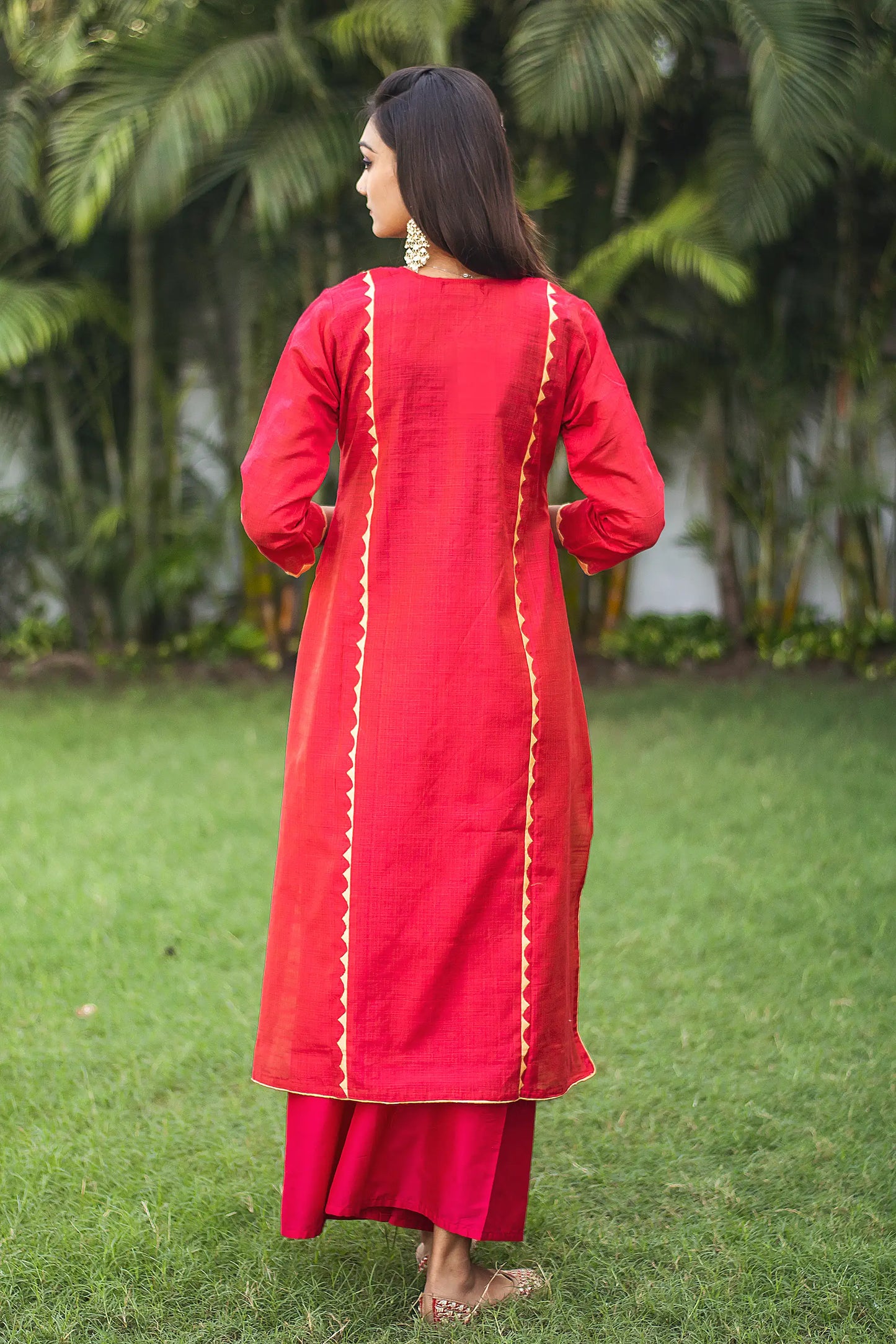 Back view of an Indian model wearing a red jute silk kurta.