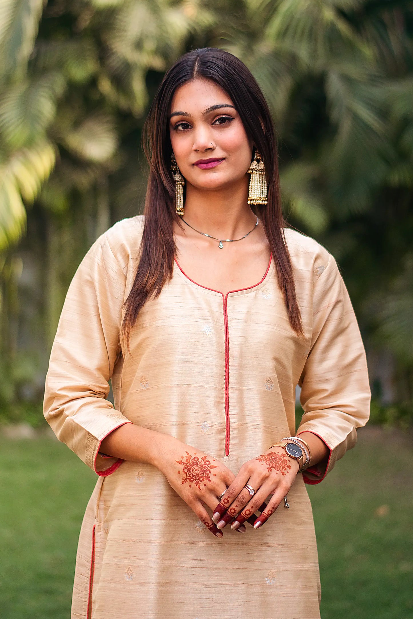 Close-up of an Indian model wearing a beige silk kurta 