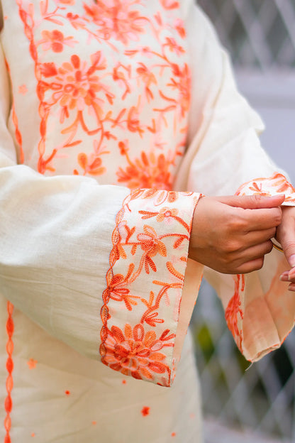 Detailed view of peach Kashmiri embroidery on the sleeve cuff of the off-white kurta.