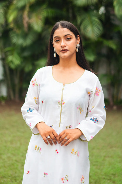 Close-up of the model focusing on the resham floral embroidery on the white chanderi kurta.