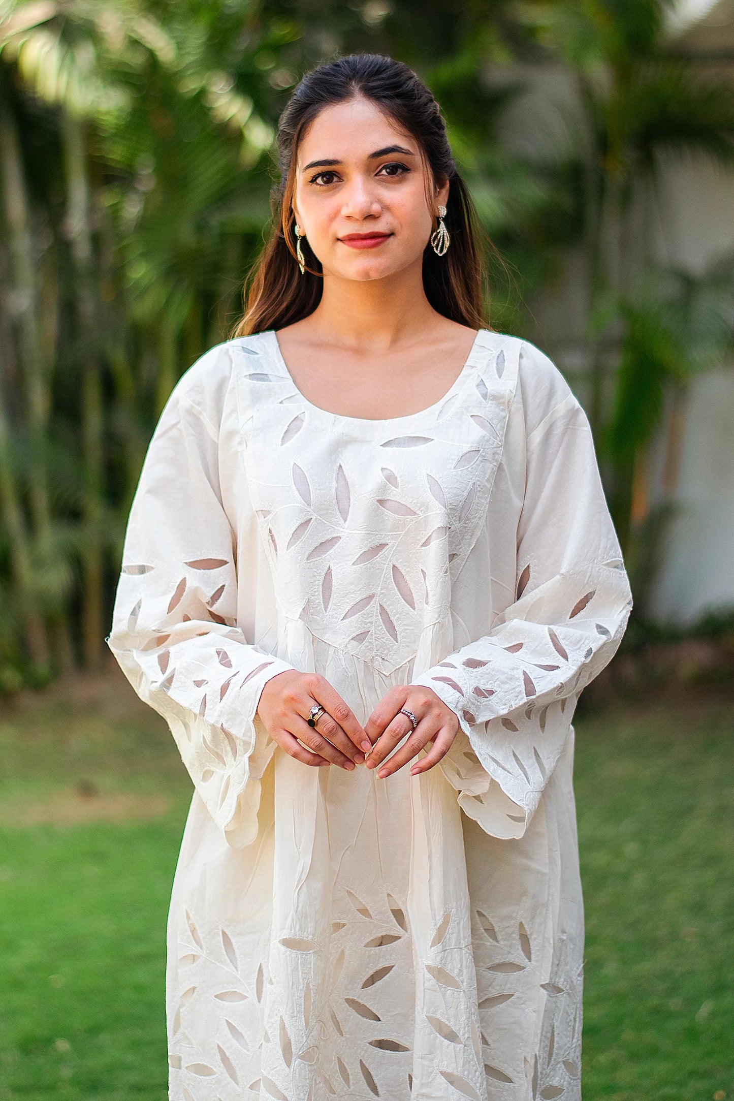 Close-up of an Indian model, highlighting the intricate floral embroidery on the yoke of the kurta.