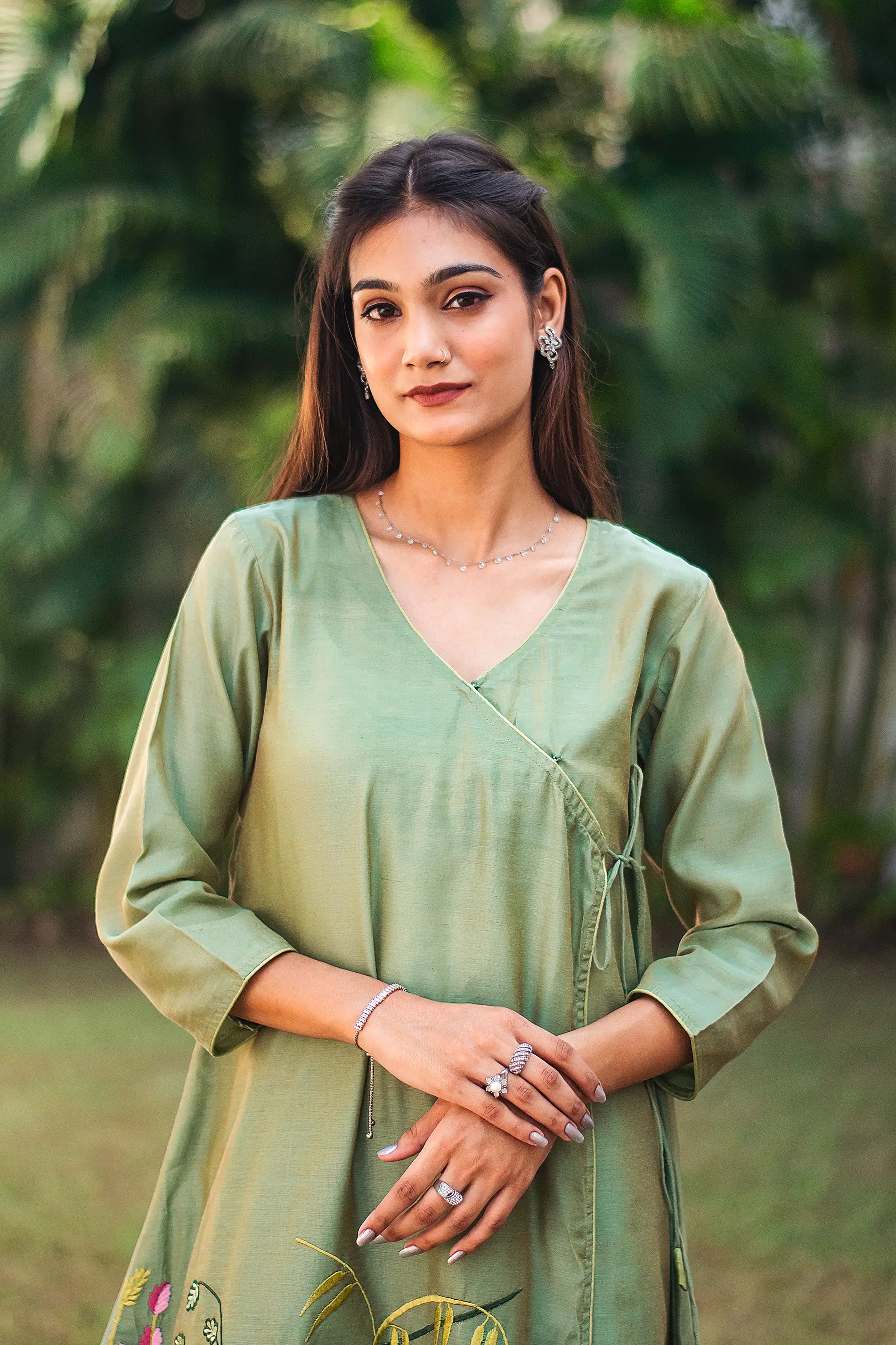 Upper half front view of a model wearing the green kurta set, featuring a green chanderi angrakha