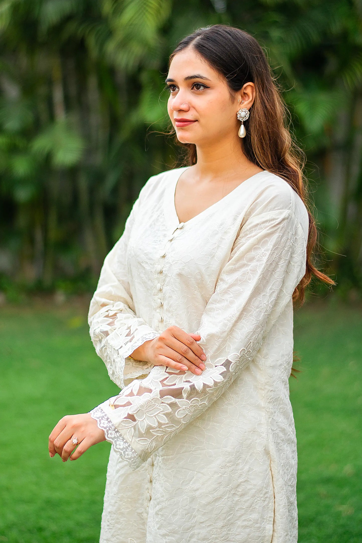 Side view of an Indian model in off-white front open kurta with floral cutw