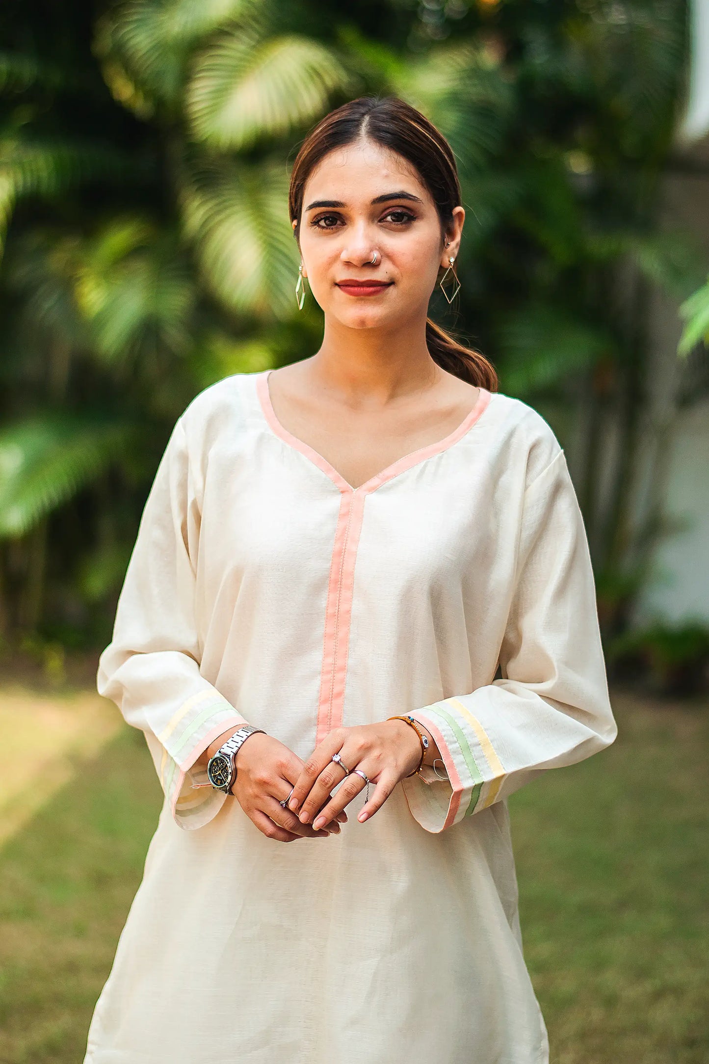 Close-up of the pastel-colored piping detail on the yoke of the off-white chanderi kurta.