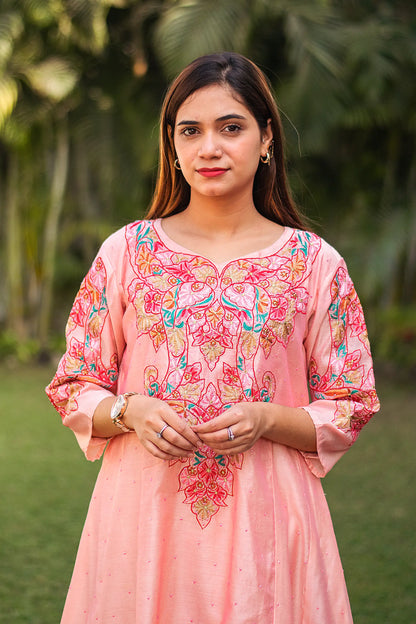 Close-up of an Indian model wearing a peach Chanderi kurta with resham embroidery,