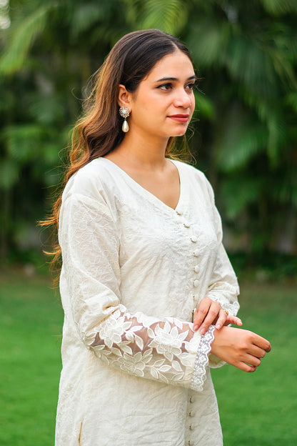 Indian model in a side profile, highlighting the white cutwork kurta with full sleeves.