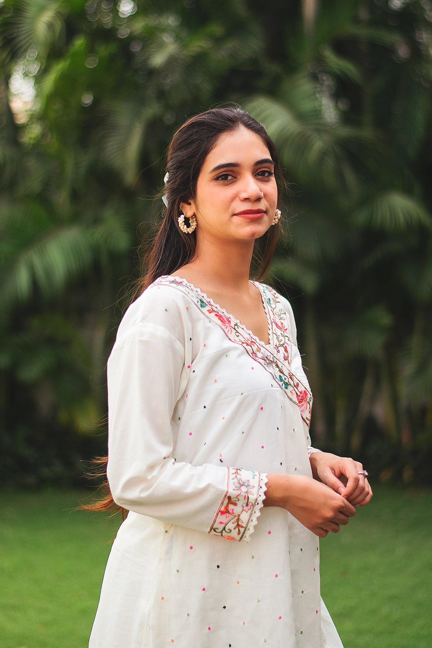 An Indian woman showcasing traditional attire in an off-white cotton angarkha