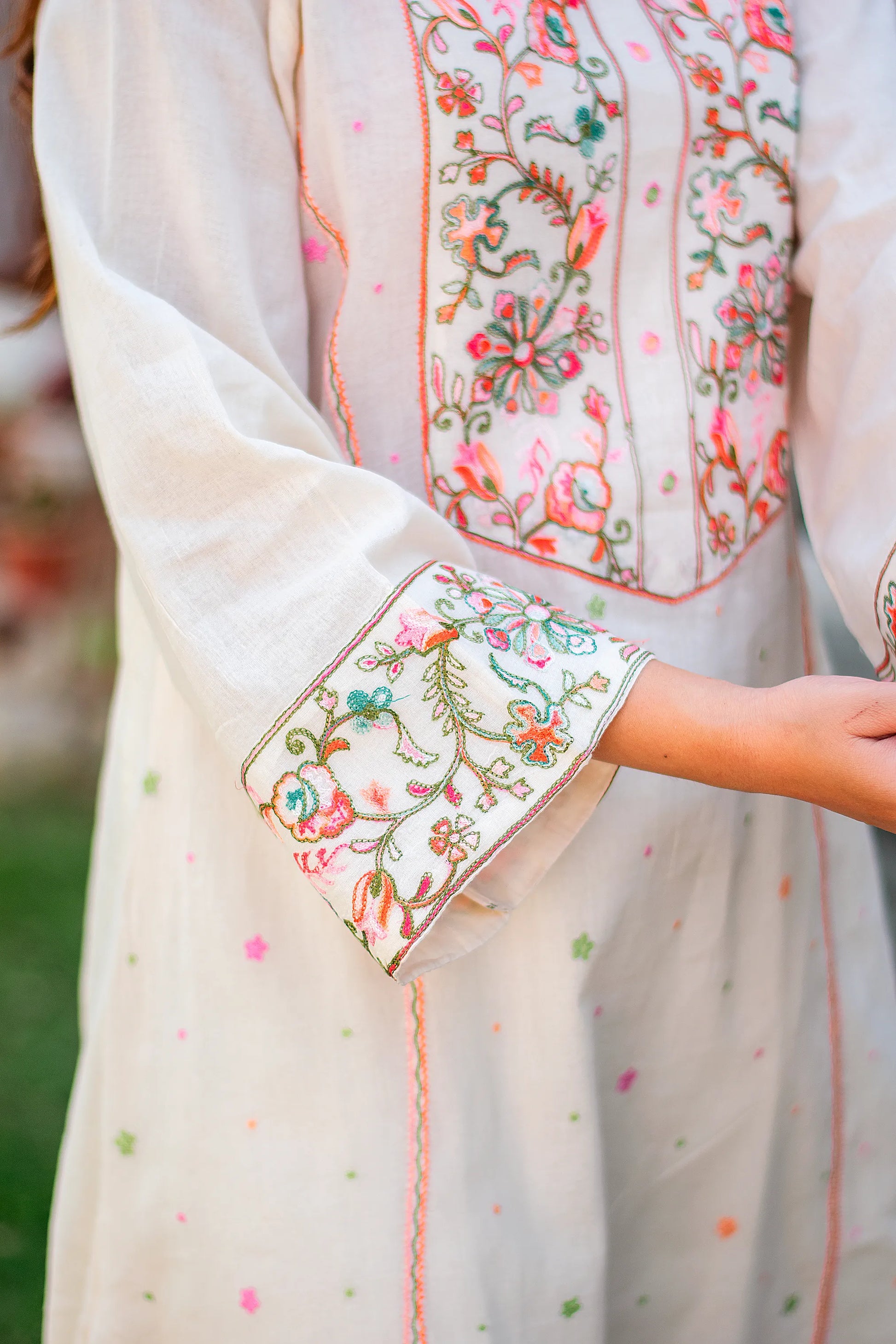 Detailed view of Kashmiri embroidery on the sleeve cuff of the off-white kurta, featuring delicate floral designs.