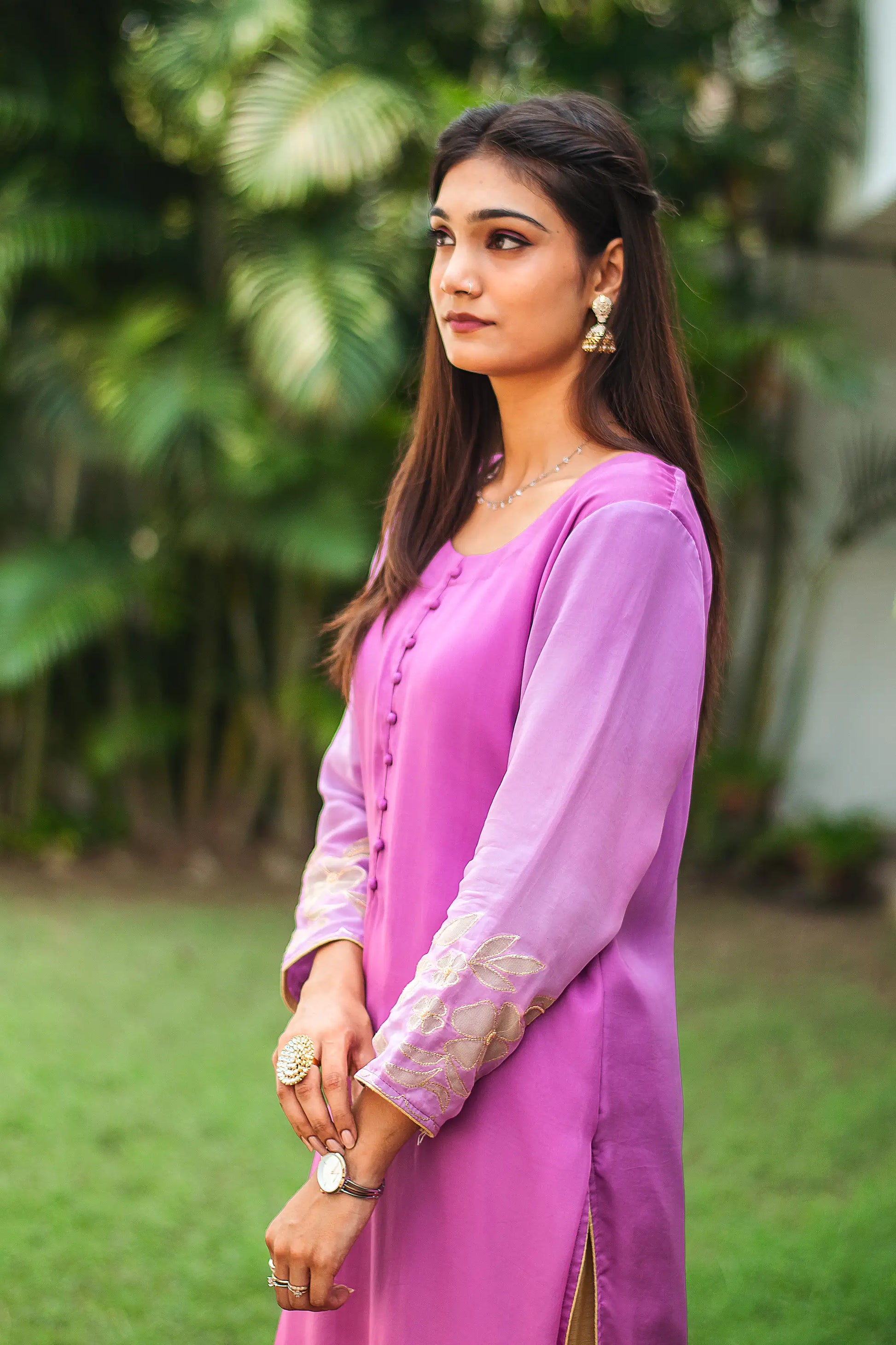 Side view of an Indian model in a light purple organza kurta, featuring golden floral cutwork around the cuffs.