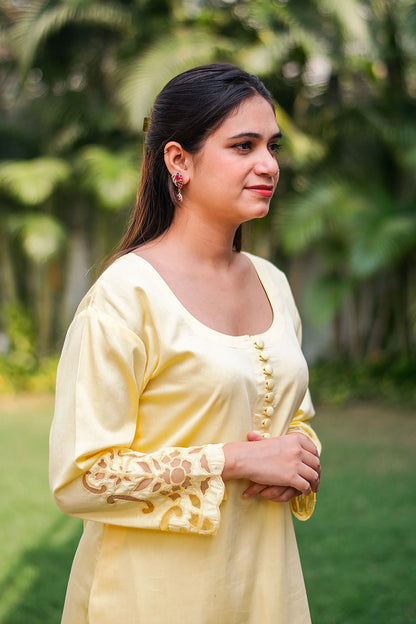 Pastel yellow russian silk kurta & trousers, peach chanderi dupatta with cutwork