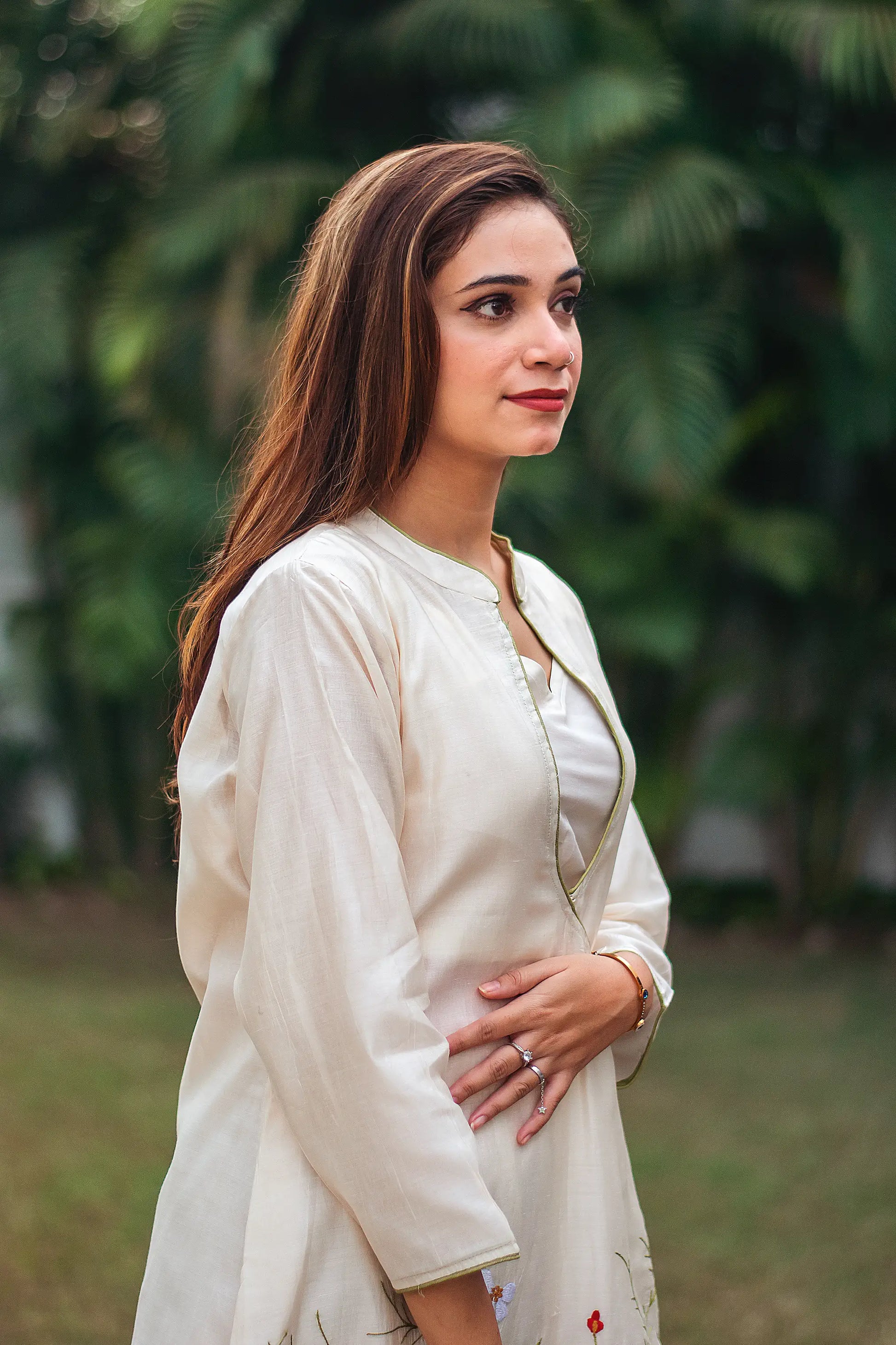 Indian model in a side pose, wearing an  off-white chanderi angrakha