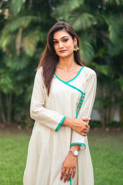 Upper half front view of a model wearing the beige chanderi angrakha set, capturing the beige chanderi angrakha