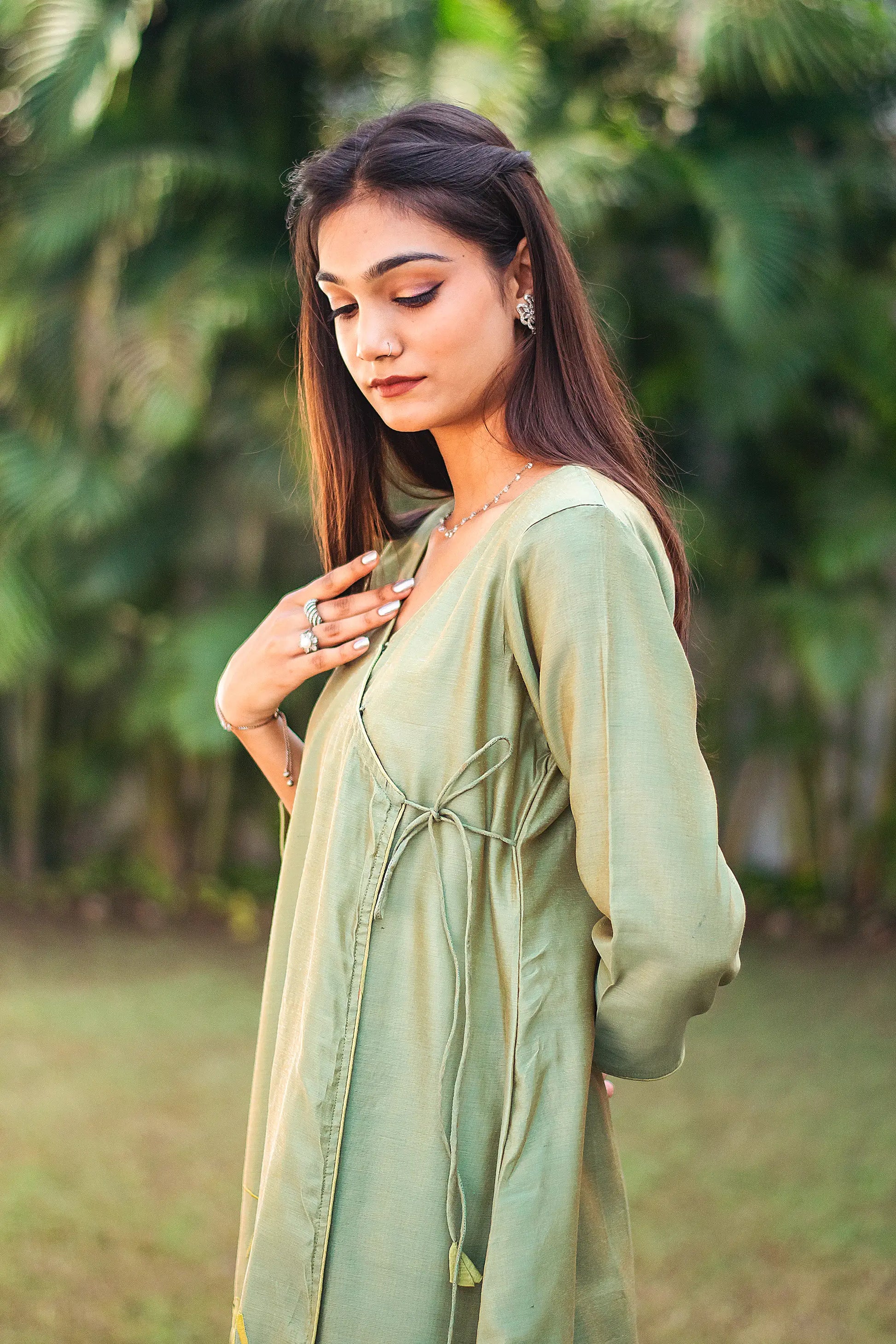 Upper left side view of a model wearing the green kurta set, highlighting the angrakha’s silhouette