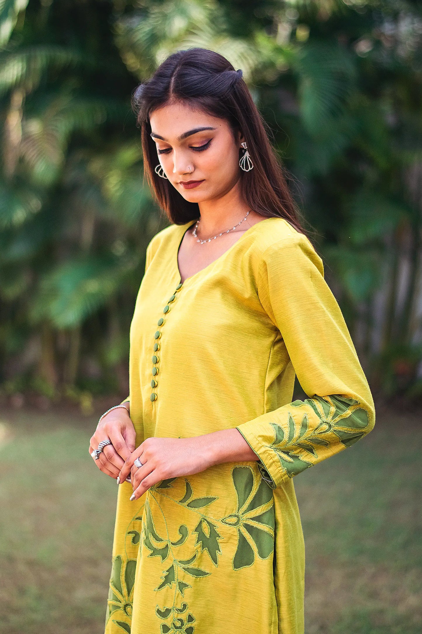 Left side view of a model wearing the cutwork kurta set, highlighting the straight fit kurta's elegant silhouette