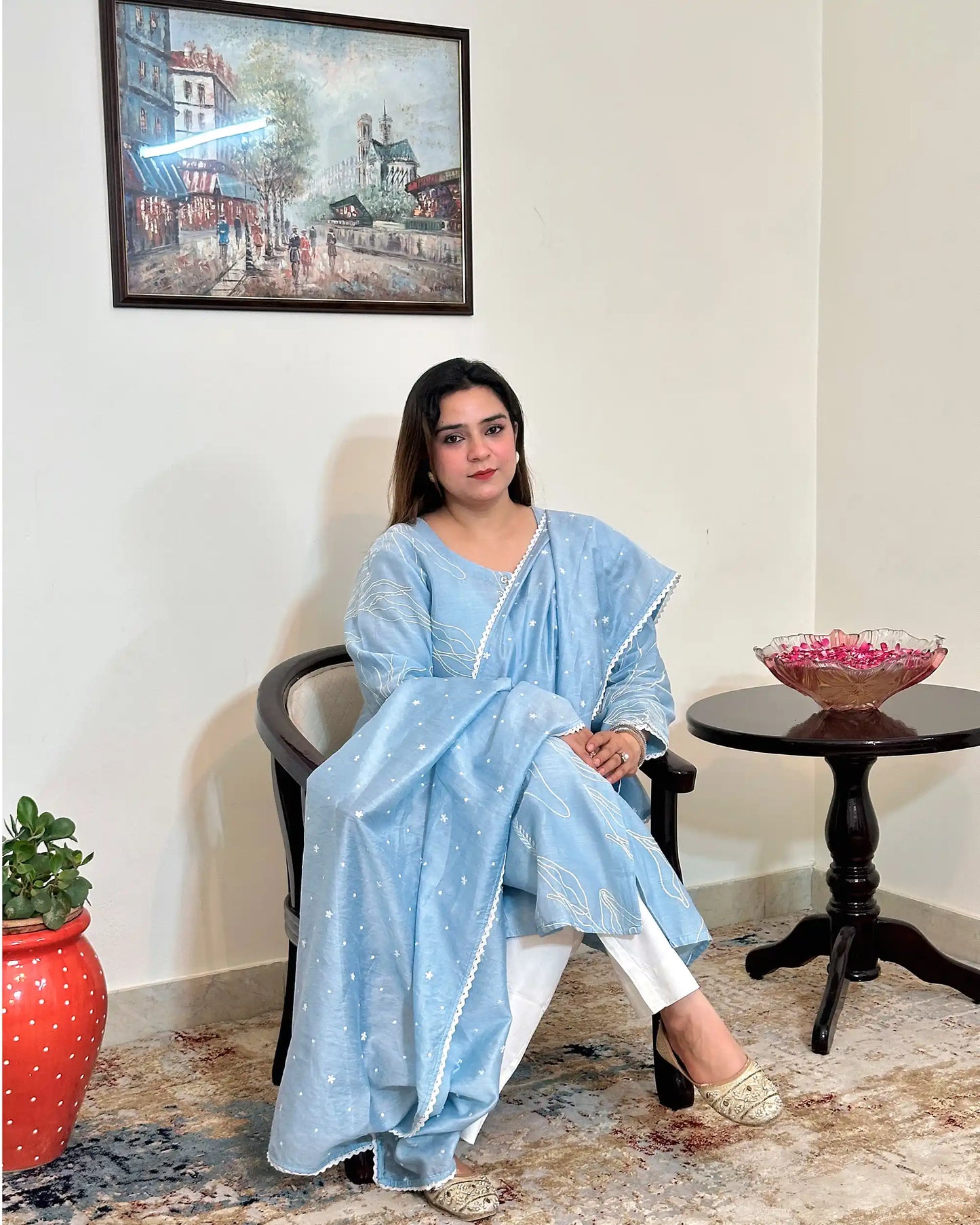 Front view of the blue chanderi A-line kurta and dupatta with white floral resham embroidery, dupatta on, worn with off-white trousers.