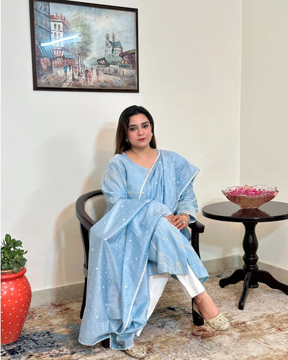 Front view of the blue chanderi A-line kurta and dupatta with white floral resham embroidery, dupatta on, worn with off-white trousers.