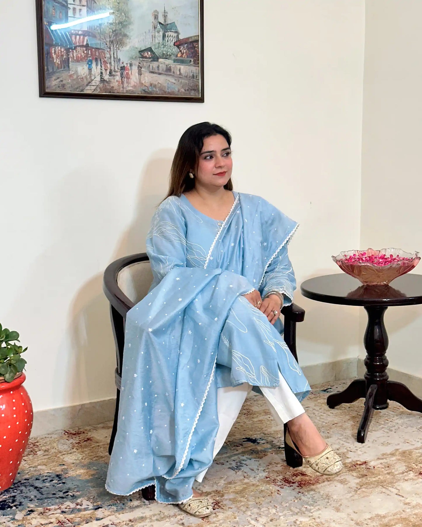 Front view of the blue chanderi A-line kurta and dupatta with white floral resham embroidery, dupatta on, worn with off-white trousers.