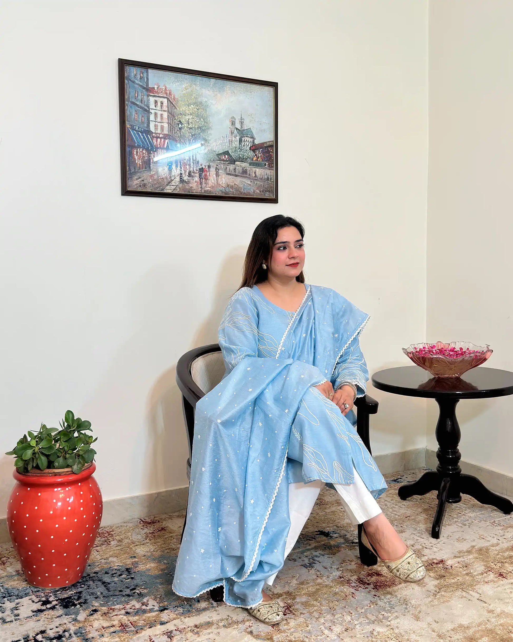 Front view of the blue chanderi A-line kurta and dupatta with white floral resham embroidery, dupatta on, worn with off-white trousers.