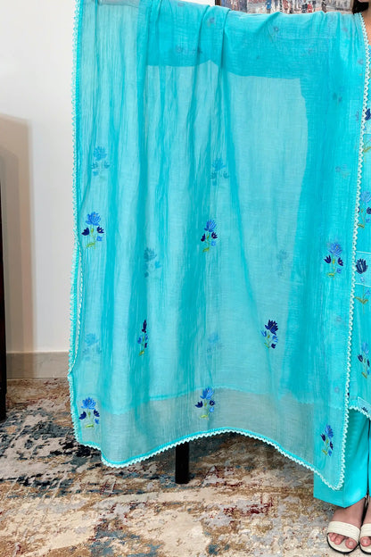 Close-up of an aqua-blue chanderi dupatta with blue floral resham embroidery and a scalloped lace edge.