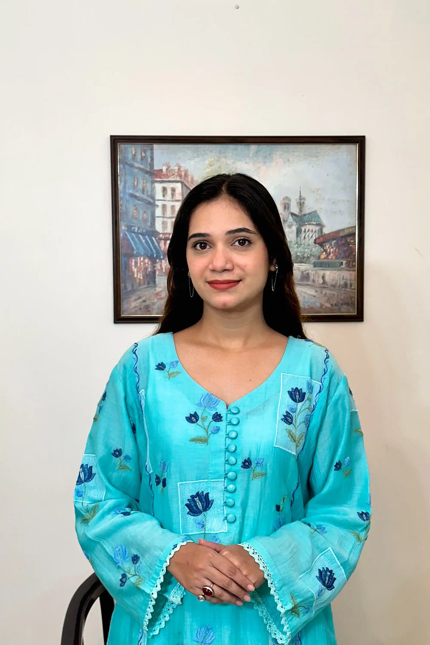 Front view of an aqua-blue chanderi kalidar kurta, featuring blue floral resham embroidery and a button placket.