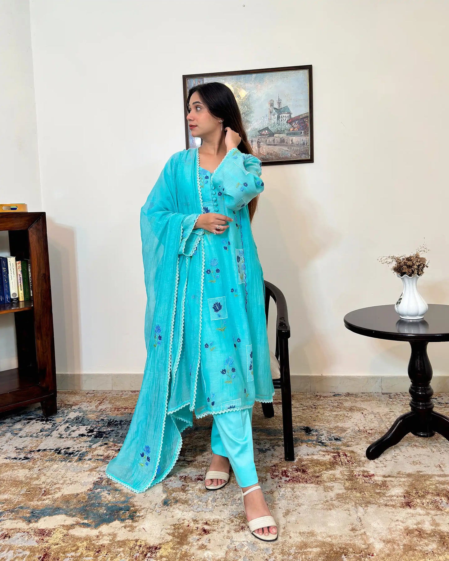 Front view of an aqua-blue chanderi kalidar kurta with dupatta on, featuring blue floral resham embroidery on both the kurta and dupatta, paired with aqua-blue trousers.