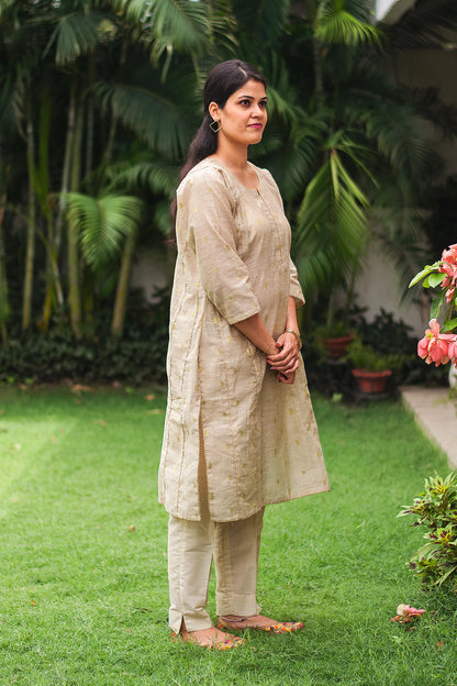 Beige double kali kurta with beige cutwork dupatta and beige trousers