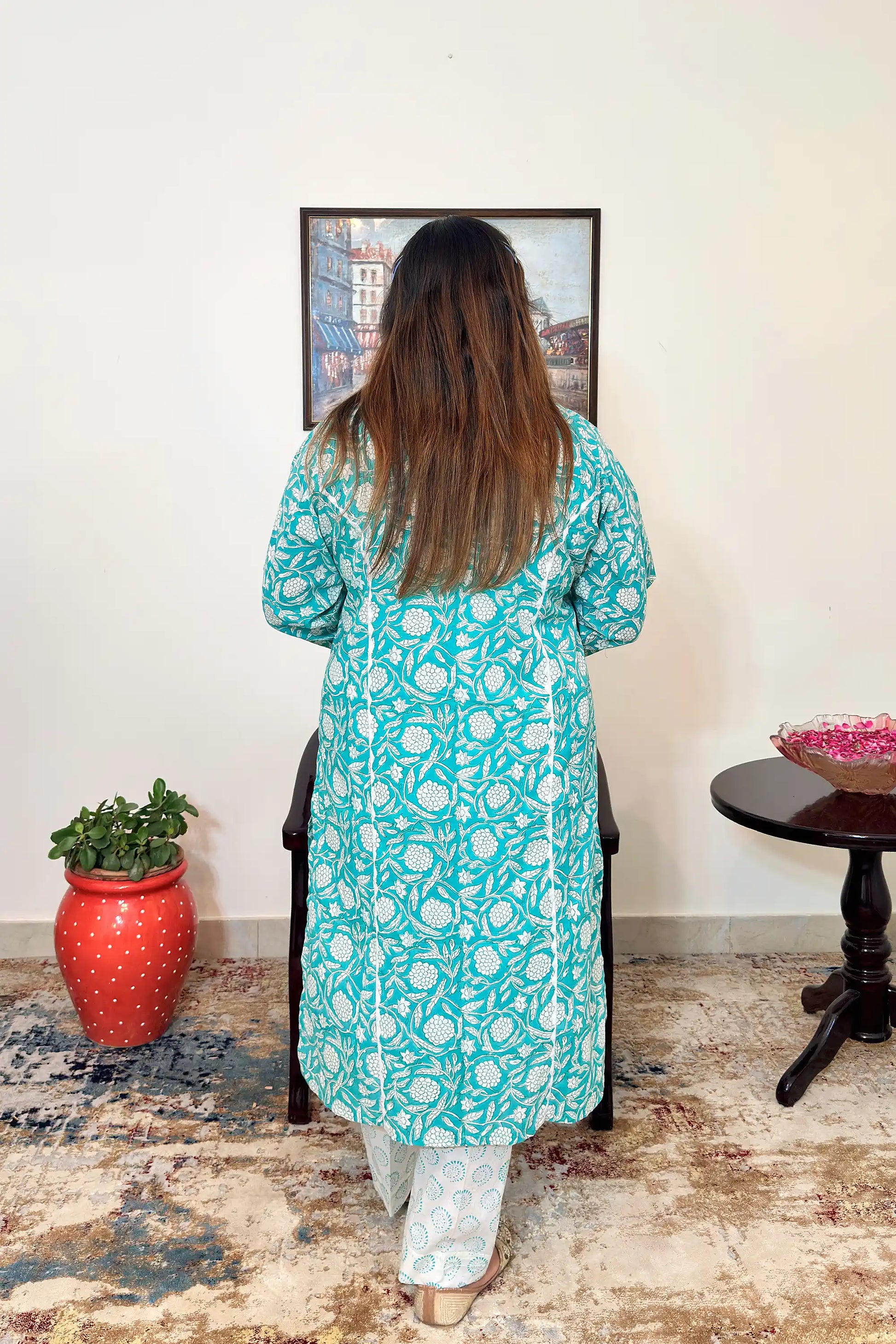 Back view of the turquoise-green mulmul cotton kalidar kurta with white floral print and applique work.