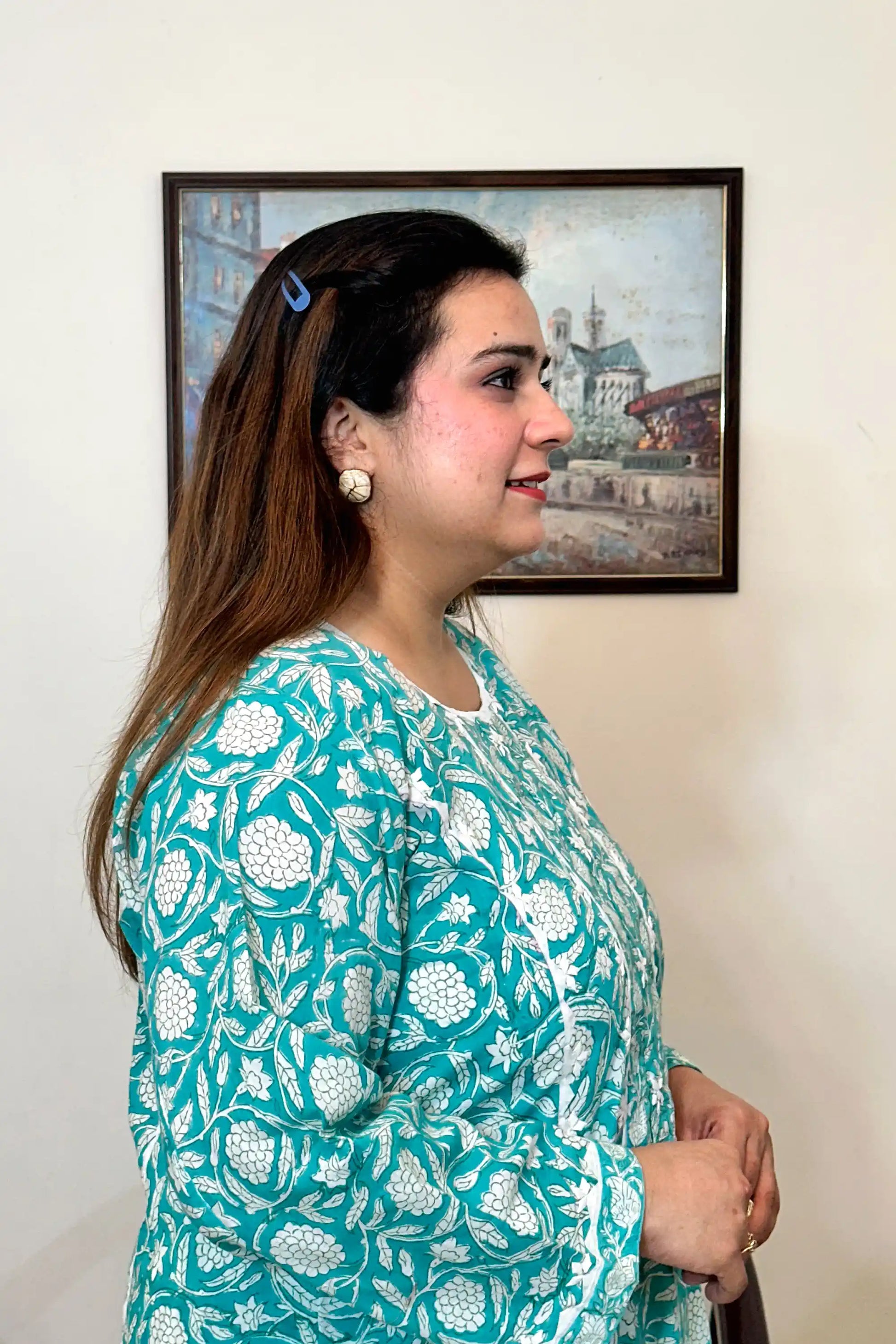 Side view close-up of the turquoise-green kurta with white floral print.