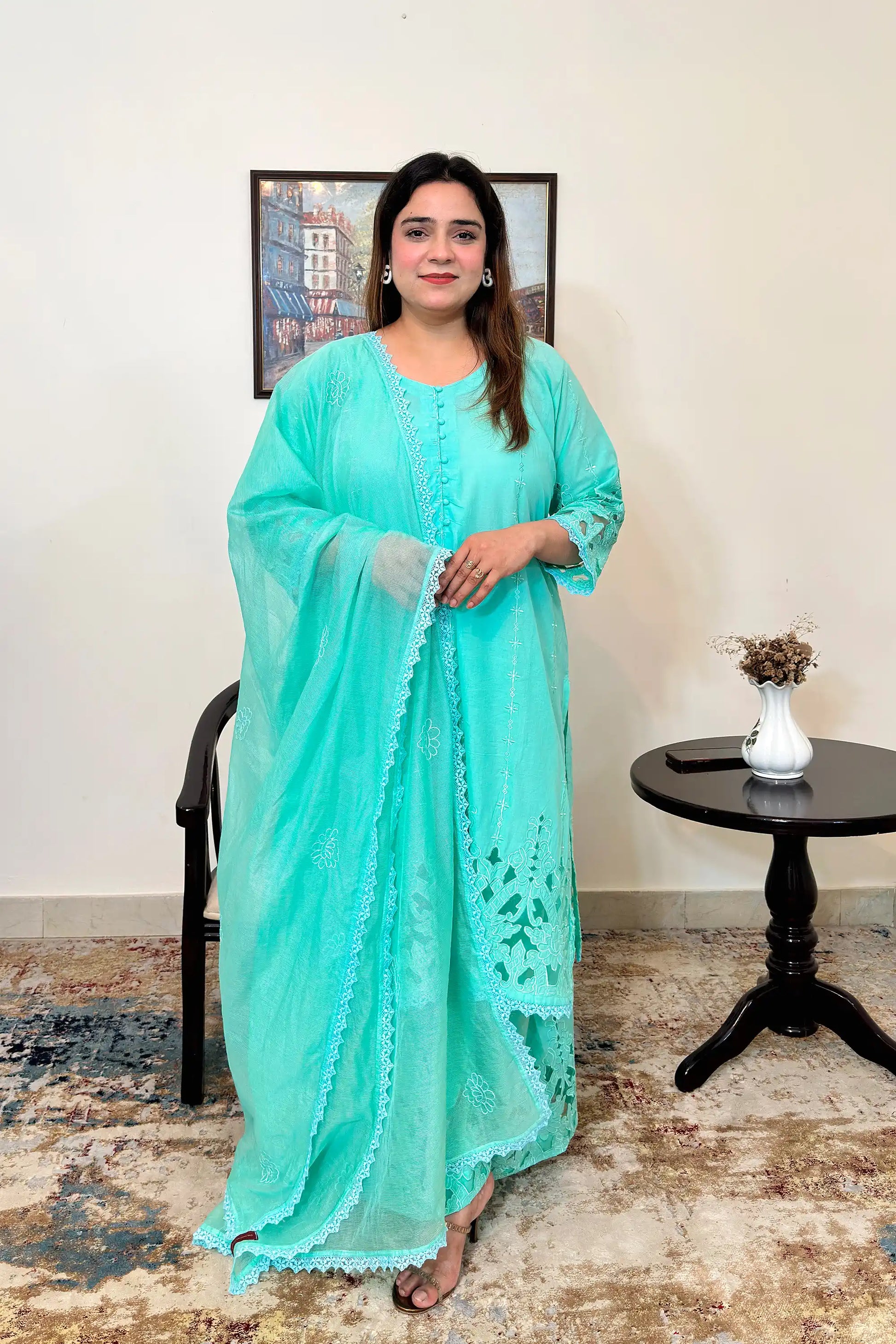 Front view of an aqua-green cotton straight kurta with floral cutwork embroidery, paired with matching aqua-green palazzo and a net dupatta with floral embroidery